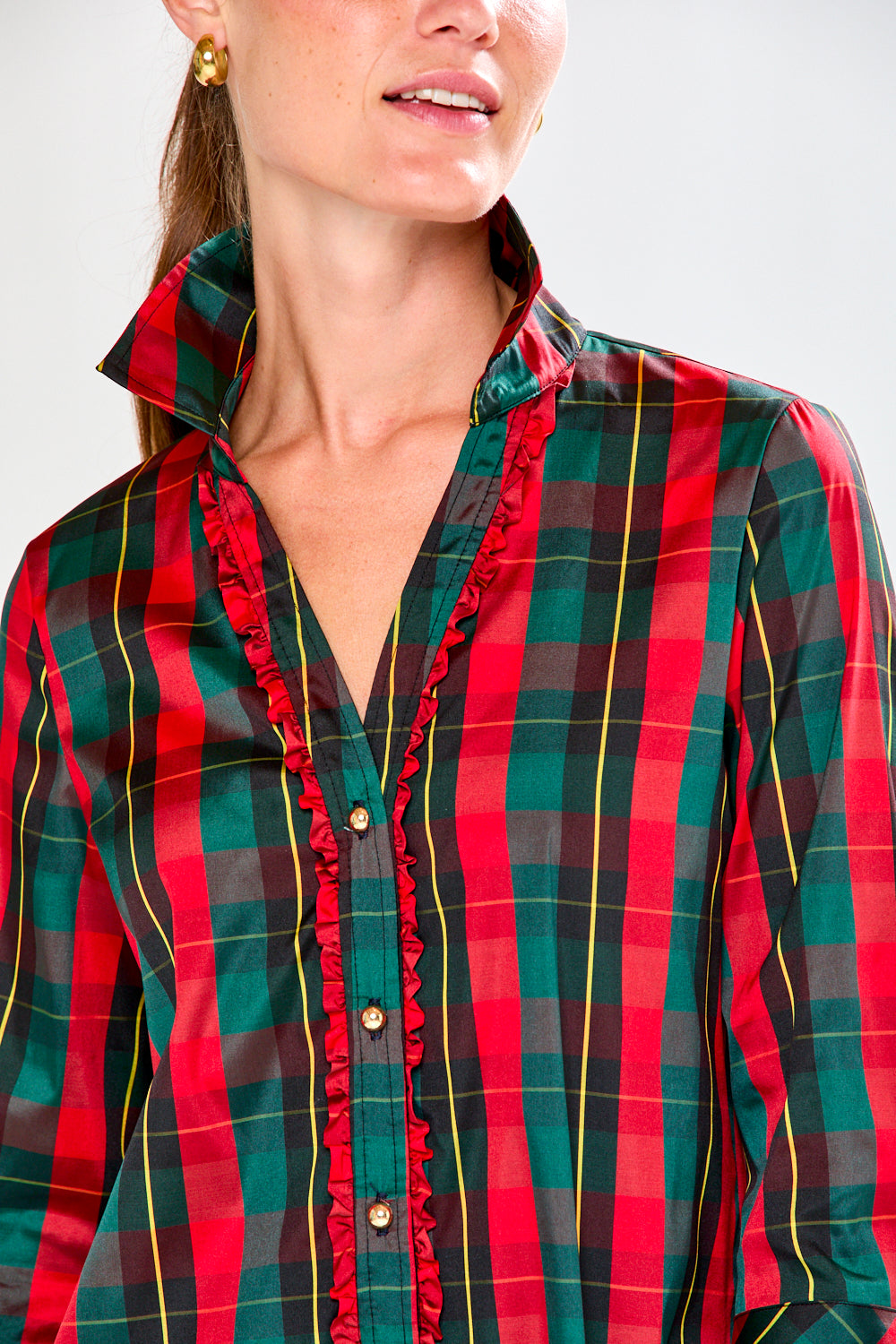 Woman wearing a red and green plaid dress on a white background