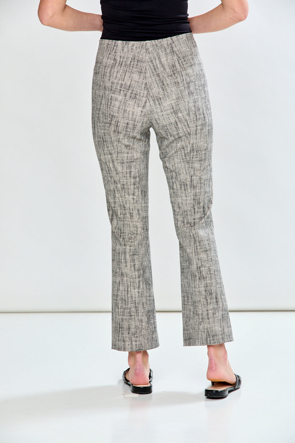 Woman in sand and black pants