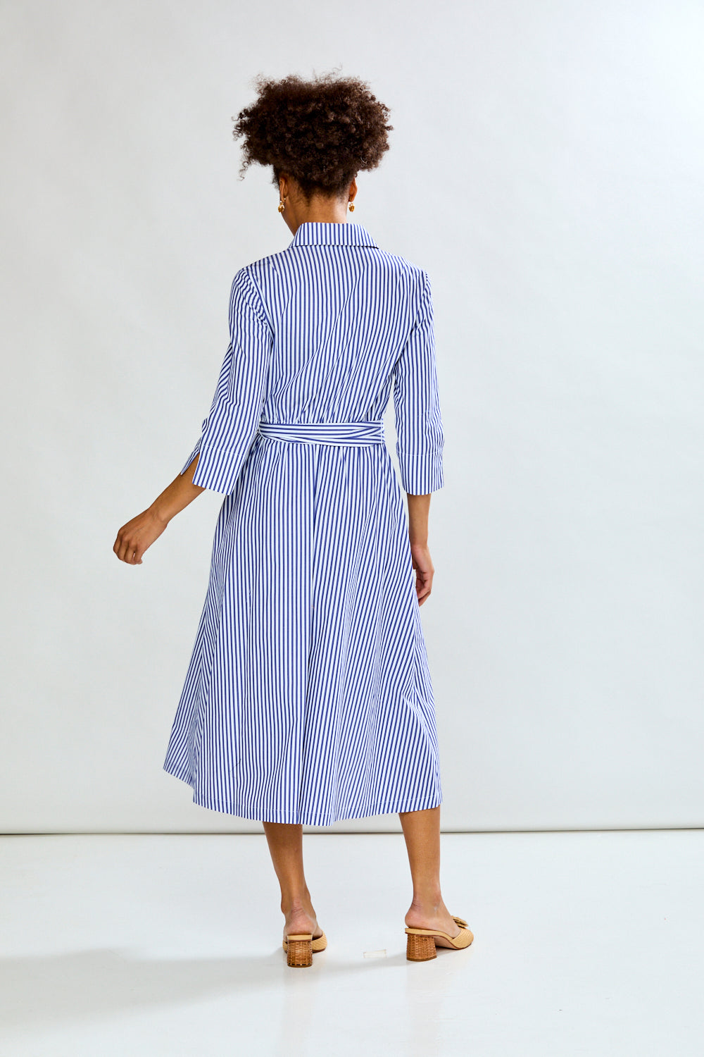 Woman in blue stripe dress