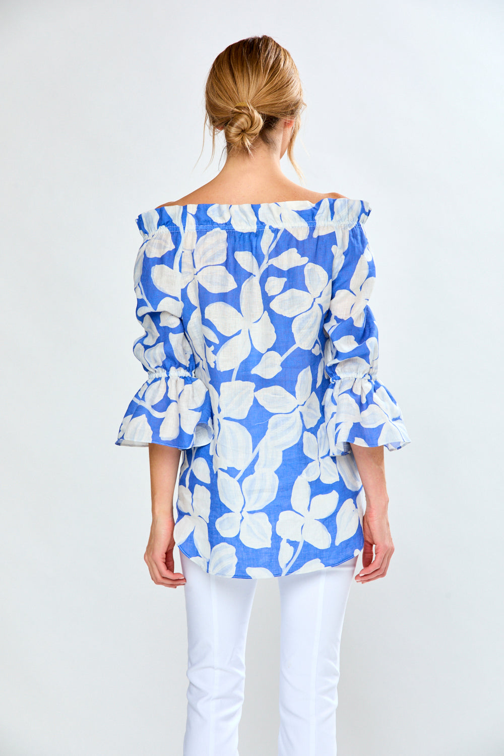 Woman in cobalt leaf print top