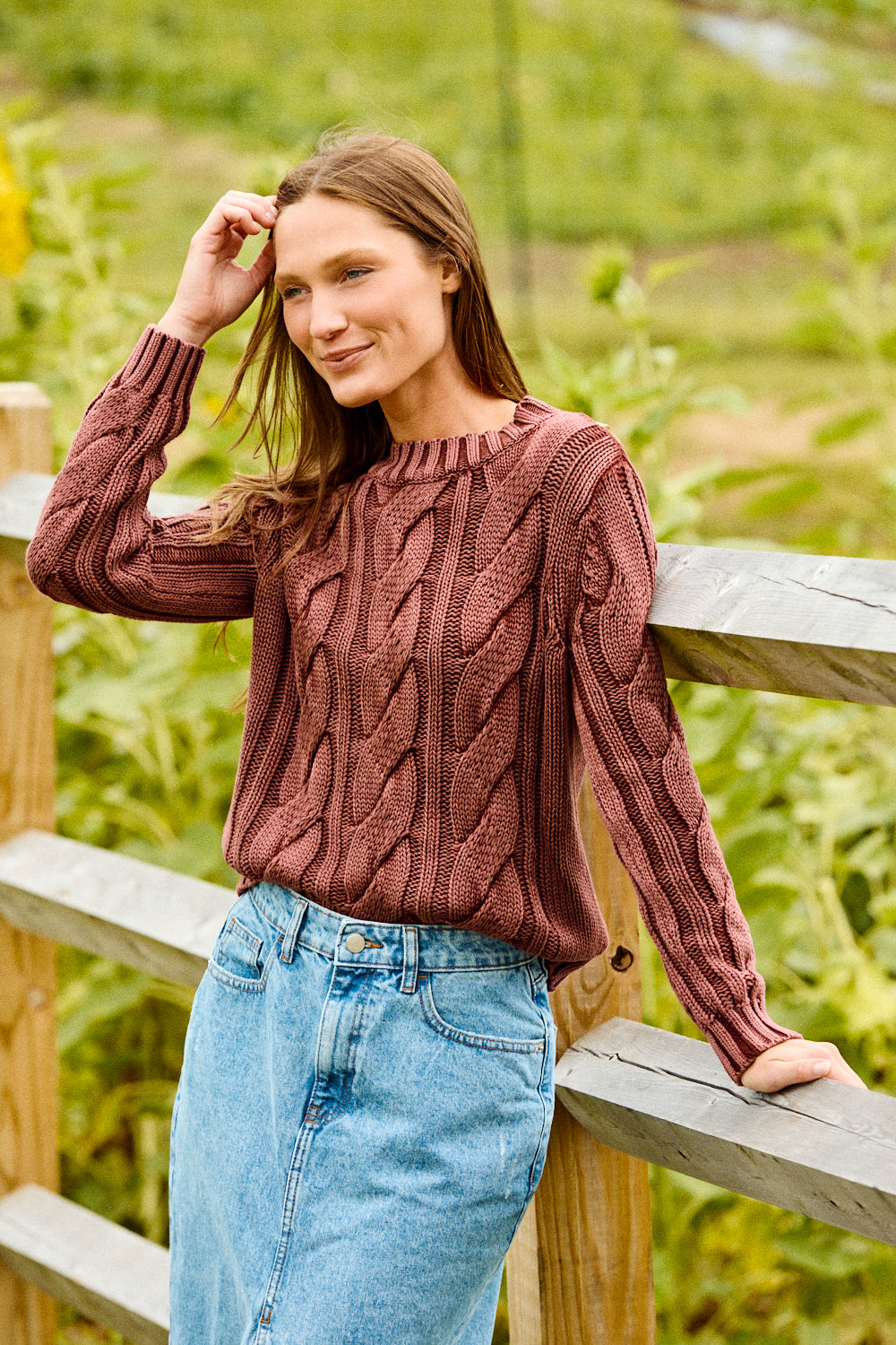 Woman wearing a raisin colored sweater