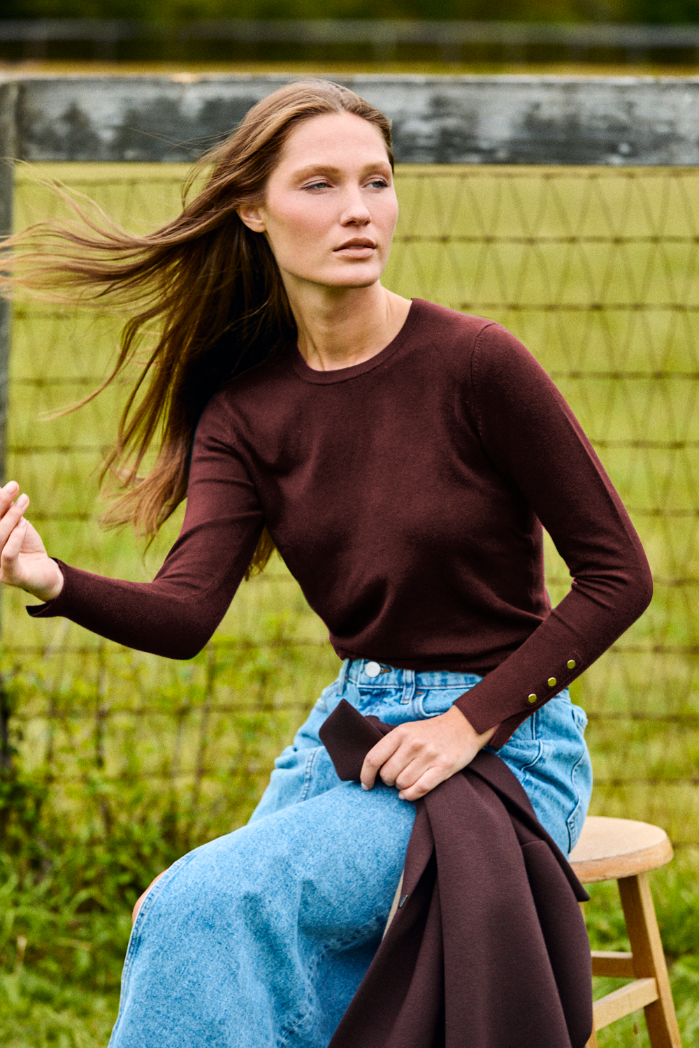 Woman wearing a brown long sleeve sweater
