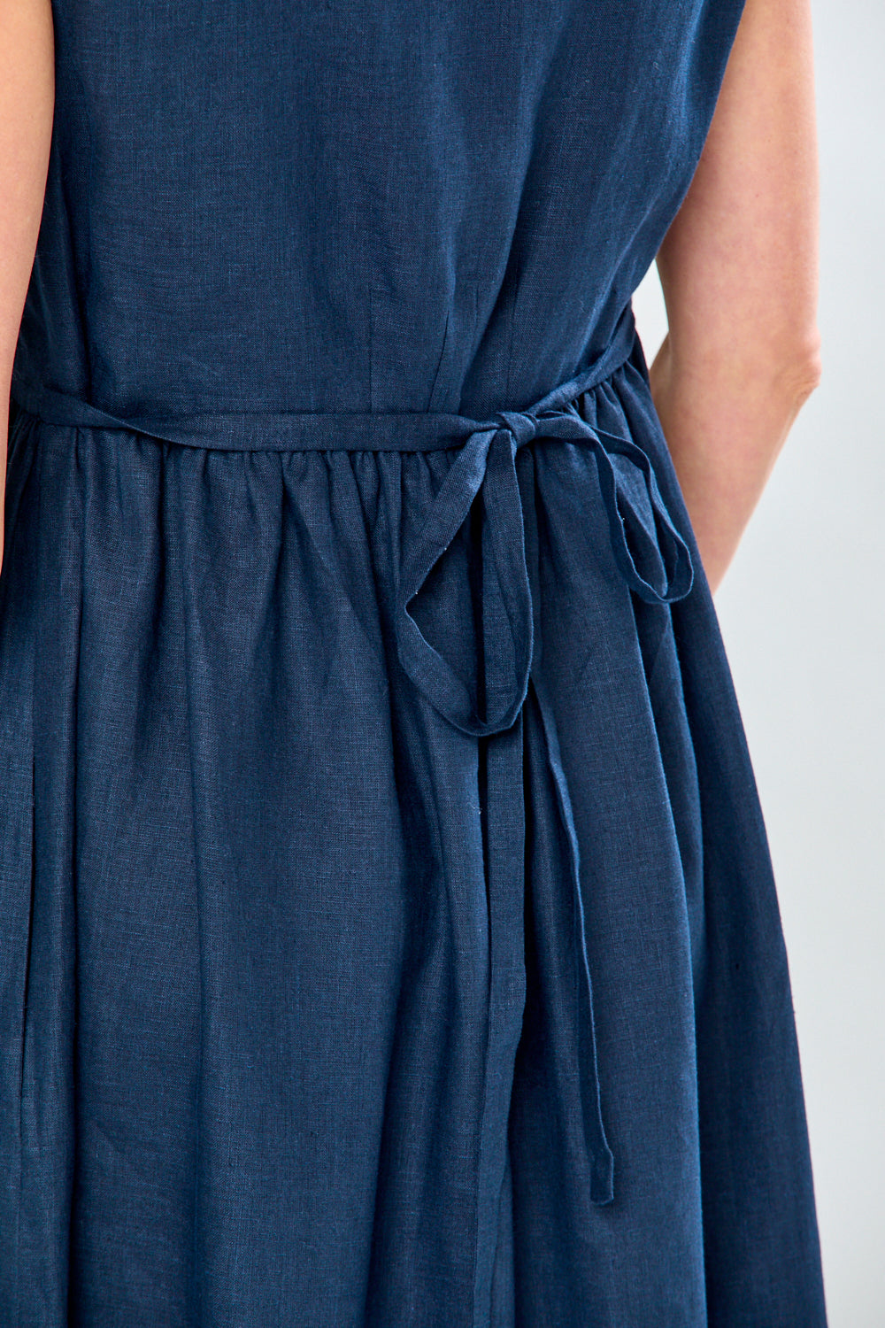 Woman in navy tea length dress