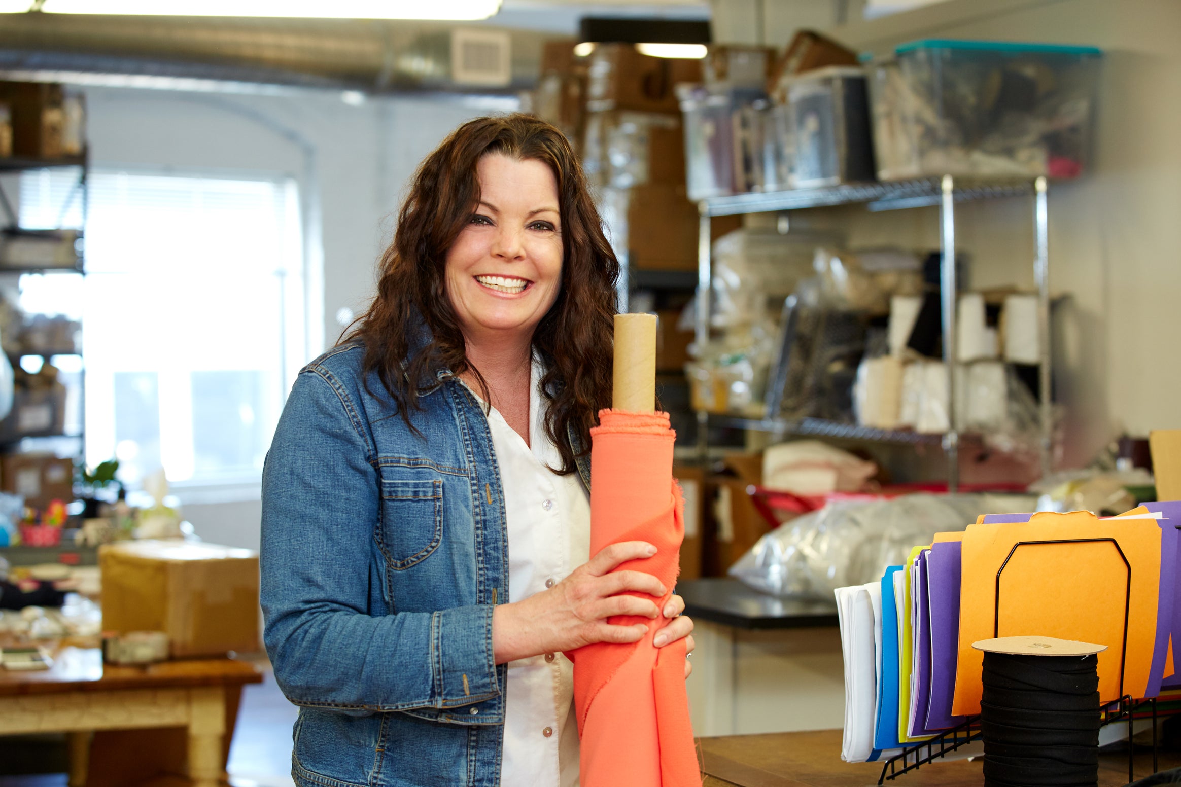 Woman holding a roll of fabric