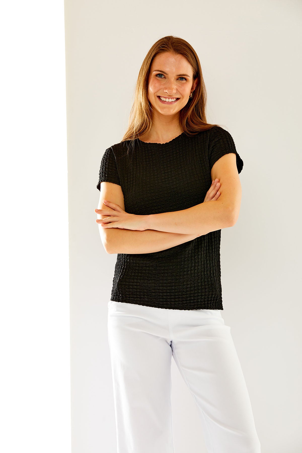 Woman in black textured knit tee