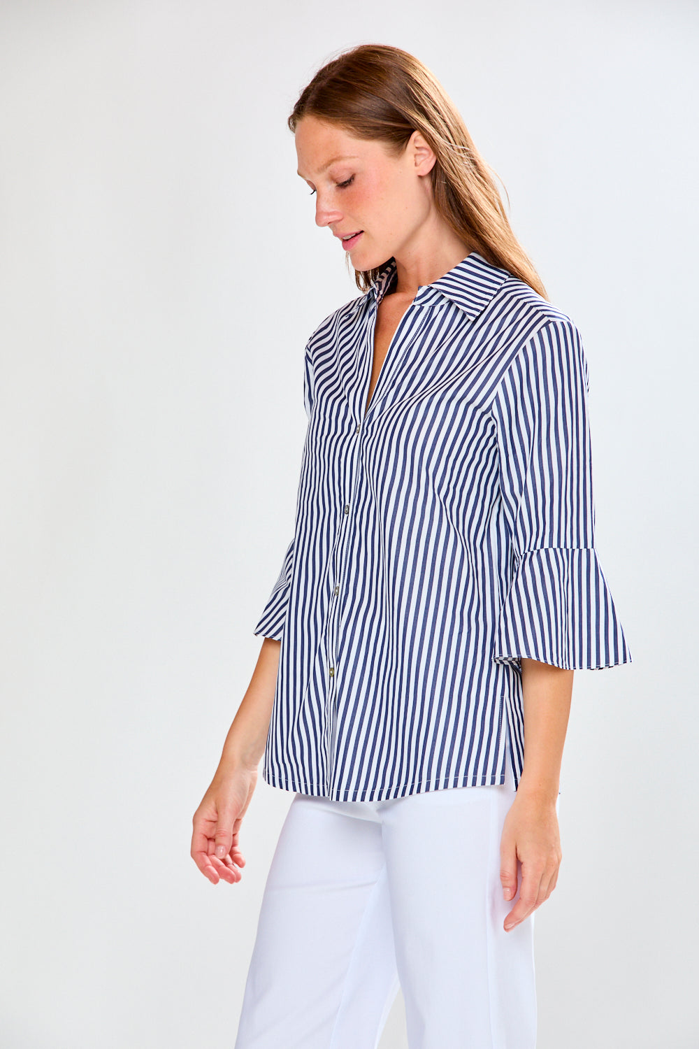 Woman wearing a blue and white striped shirt on a white background
