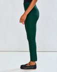 Person wearing evergreen pants on a white background