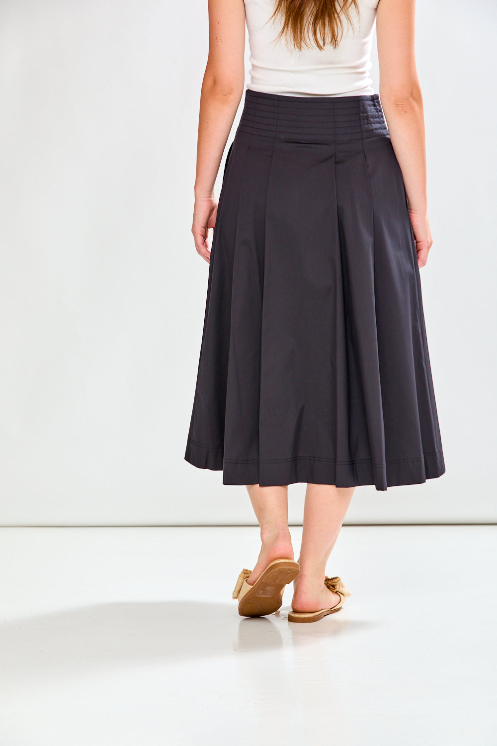 Person wearing a black skirt on a white background