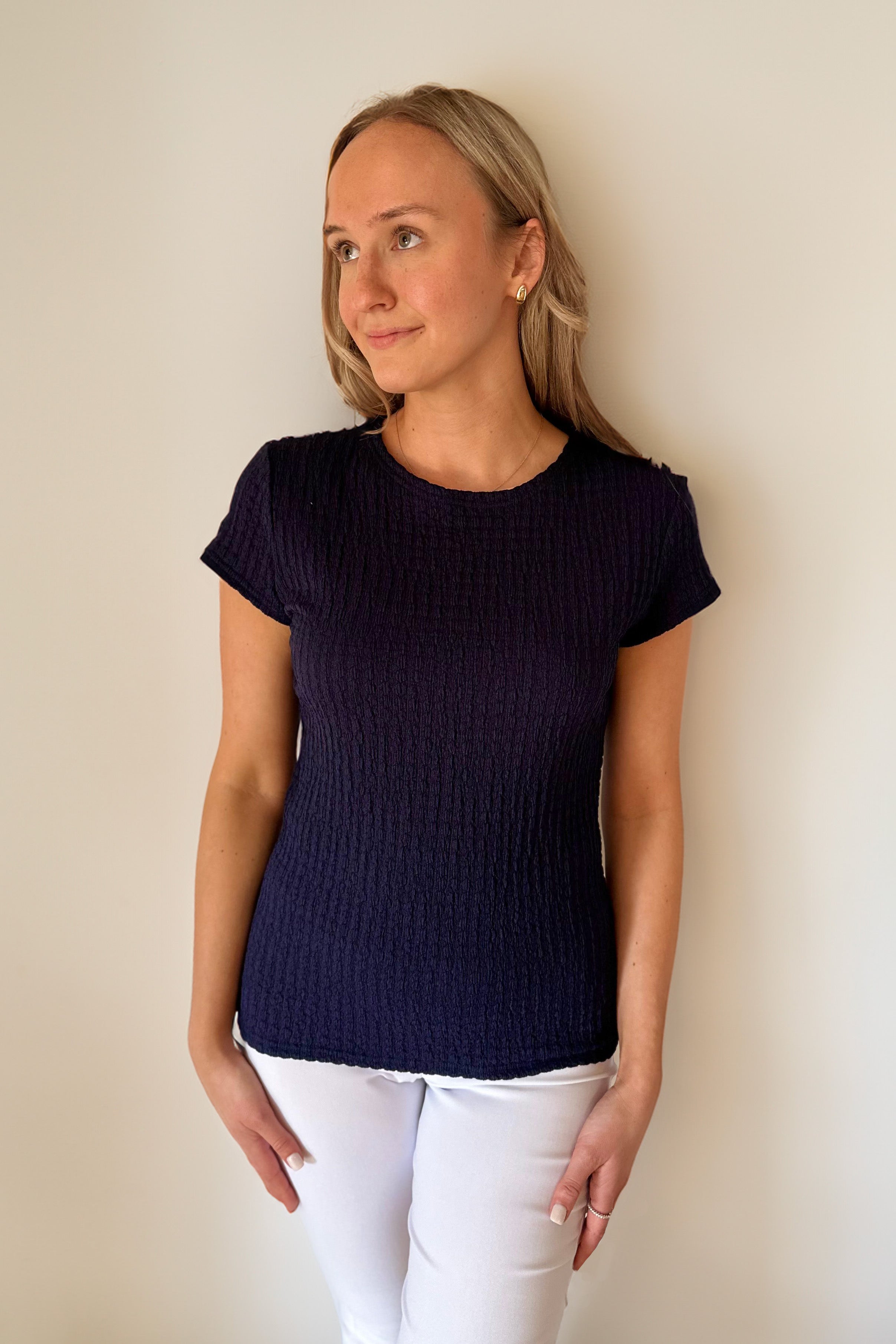 Woman in navy textured knit tee