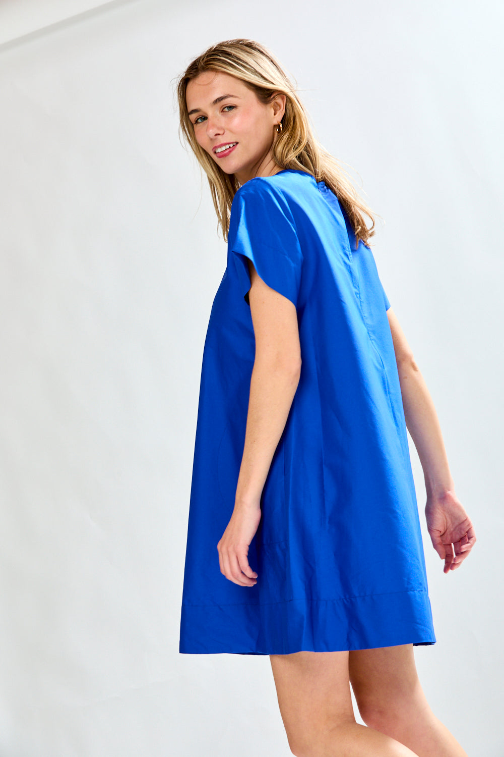 Woman in blue poplin short dress