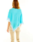 Woman in aqua poncho