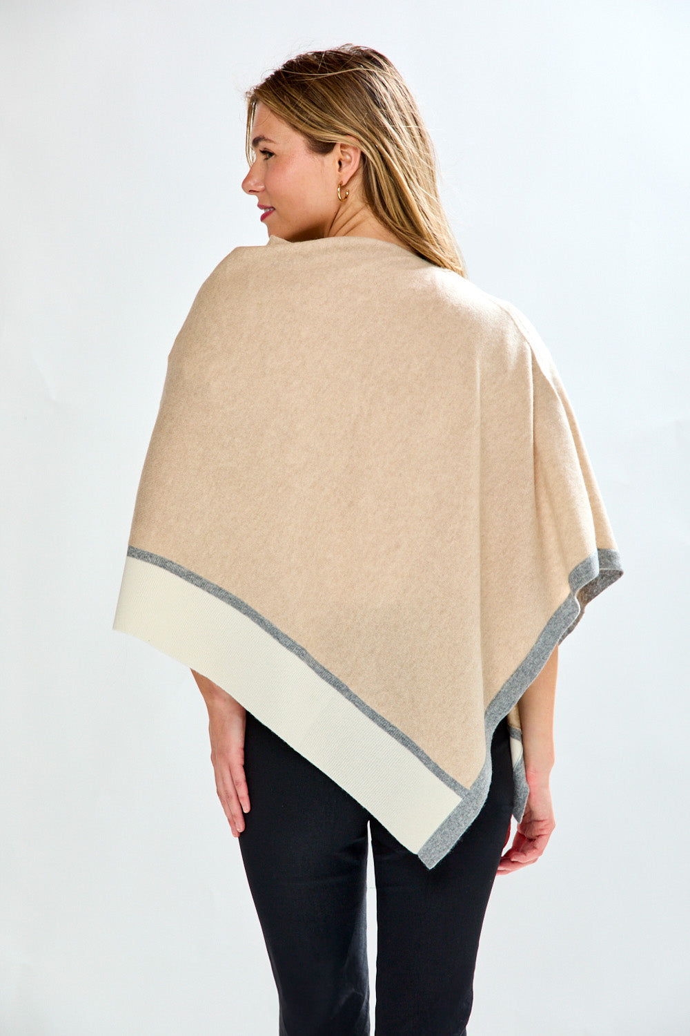 Woman in sand tipped poncho