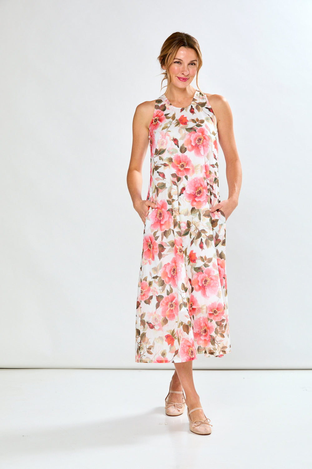 Woman in coral poppies dress