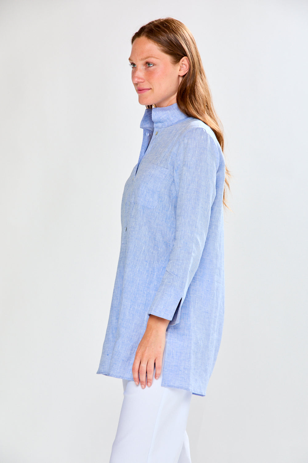 Woman wearing a light blue shirt against a white background