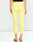 Person wearing yellow pants and a black top on a white background