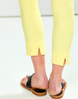 Person wearing yellow pants and black sandals on a white background