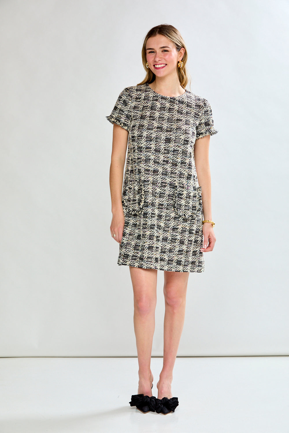 Woman wearing a patterned dress against a white background