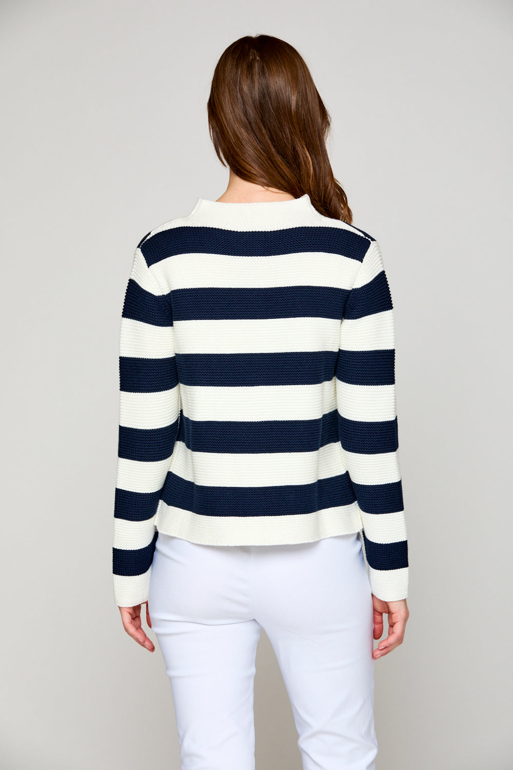 Woman in striped mock neck sweater
