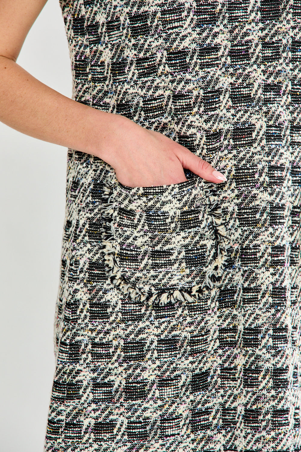 Close-up of a patterned dress with a pocket on a plain background