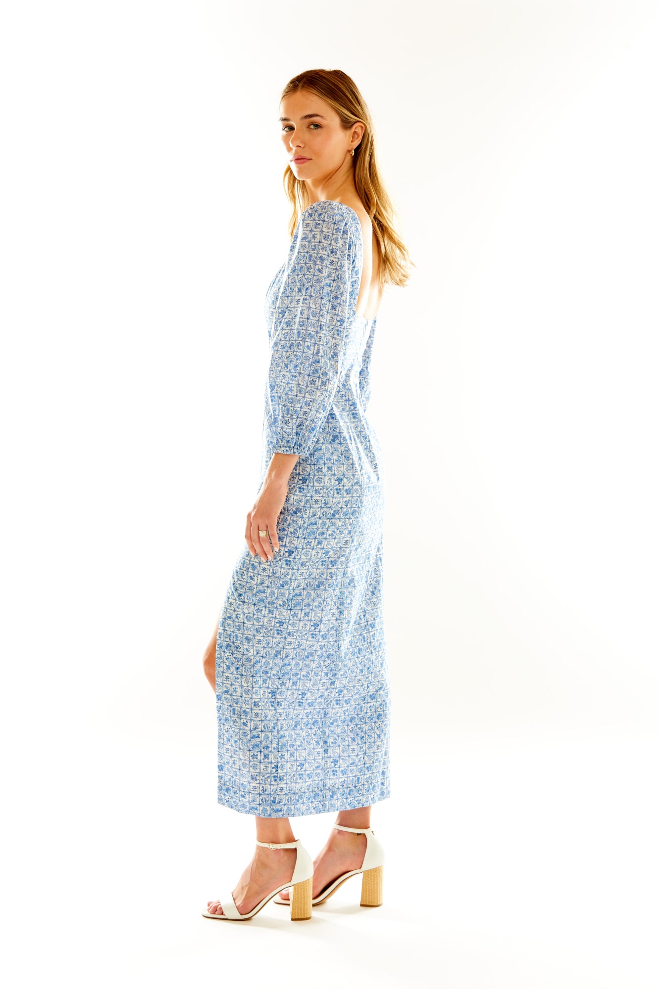 Woman in blue floral long sleeve column dress