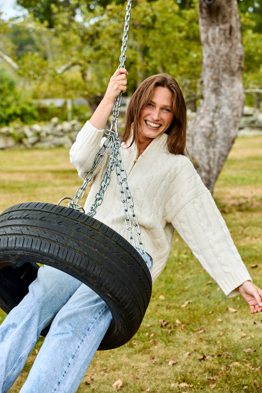 Woman swinging on a tire swing in a park