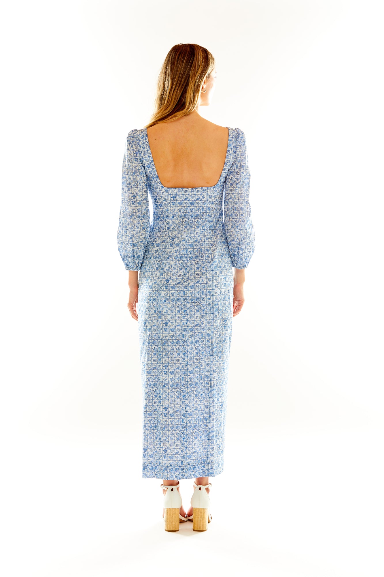 Woman in blue floral long sleeve column dress