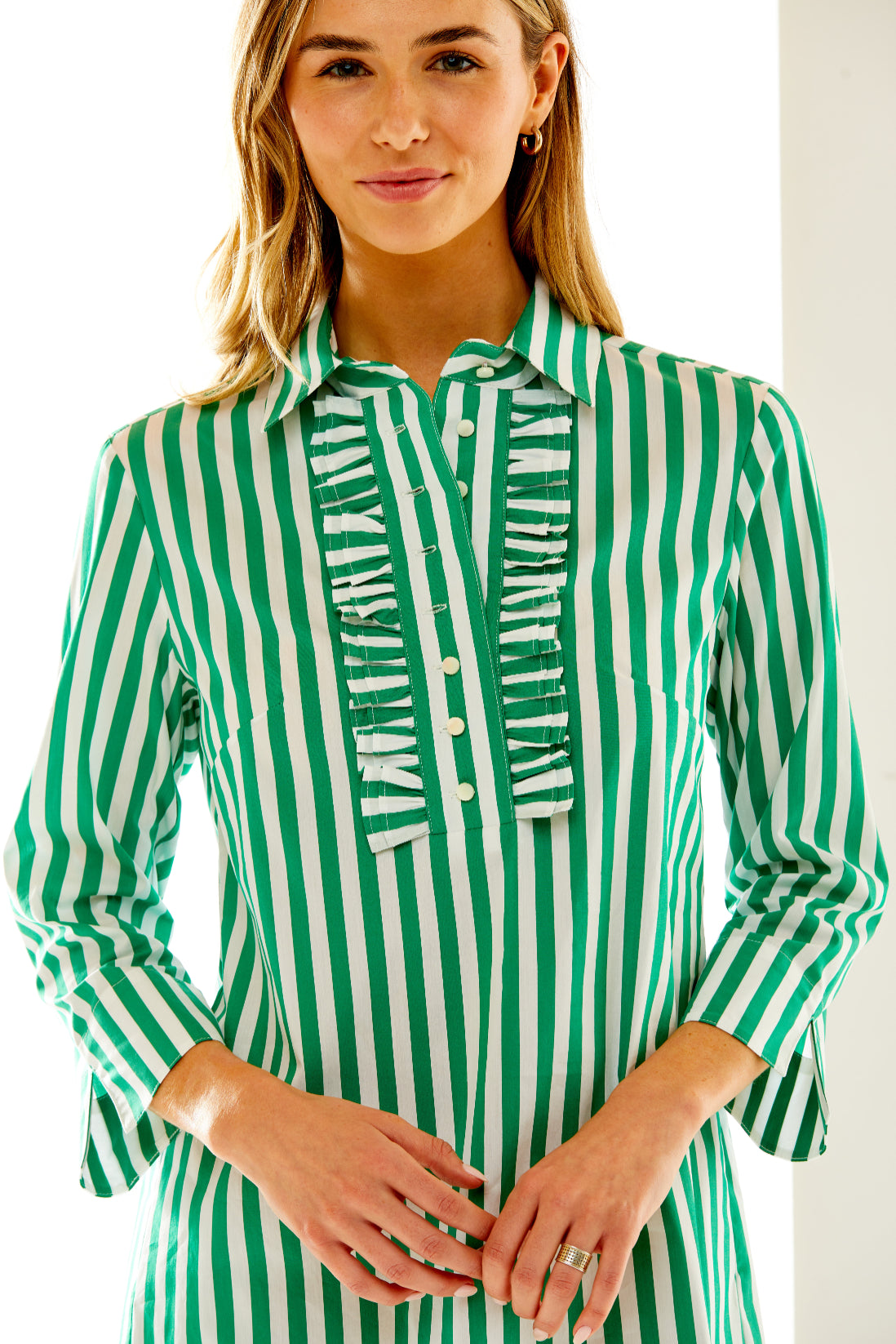 Woman in green and white striped dress