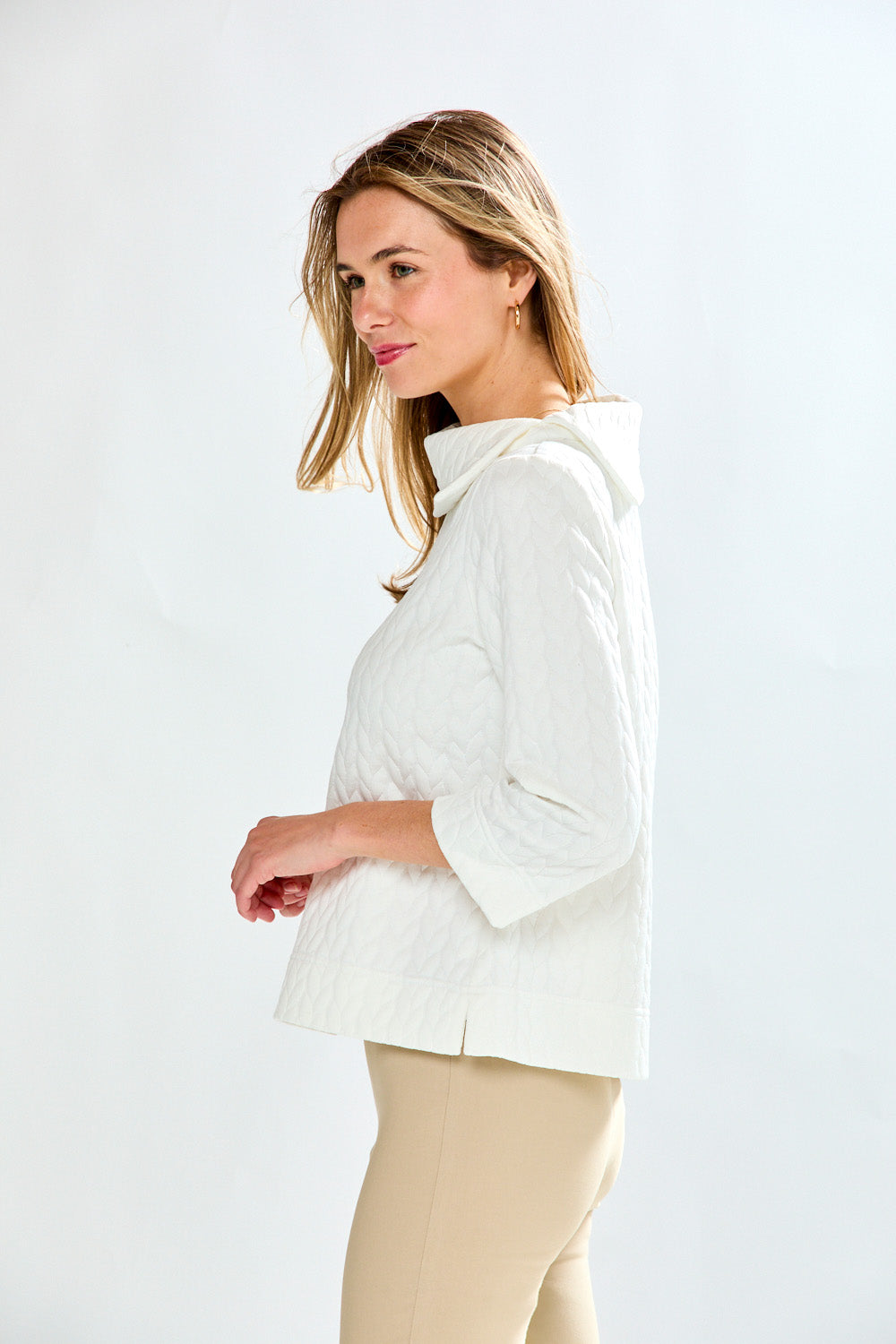 Woman wearing a white blouse with a plain background
