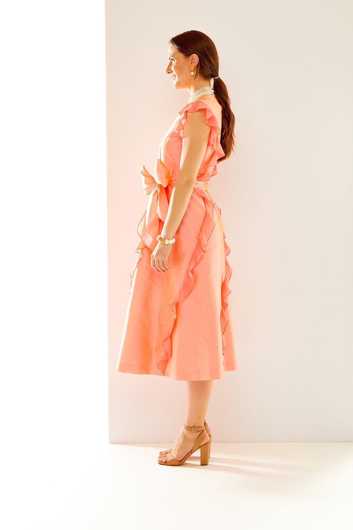 Woman in coral taffeta dress