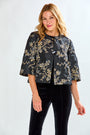 Woman wearing a black floral jacket and black pants on a white background