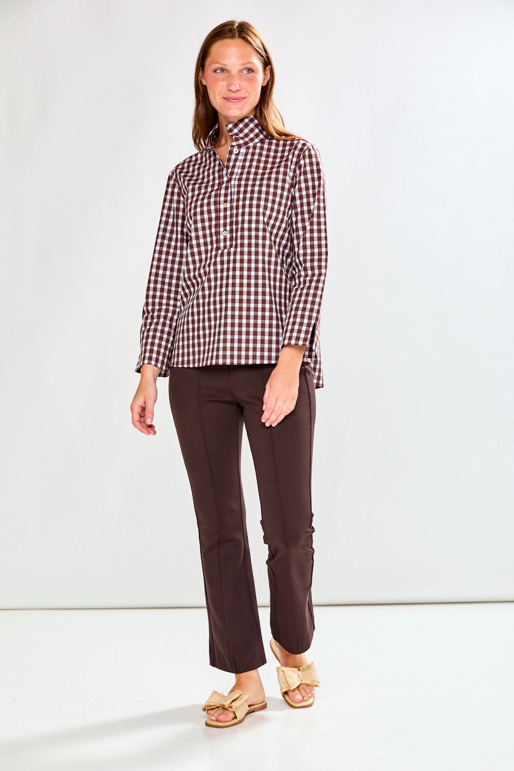 Woman in chocolate/white check top