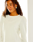 Woman in white cable knit top