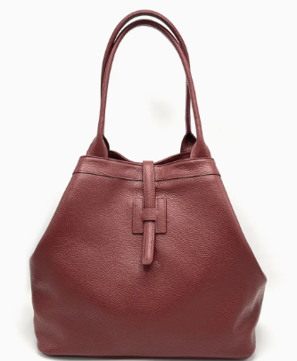 Bordeaux leather handbag with a prominent logo on a white background