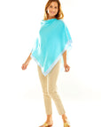 Woman in aqua poncho
