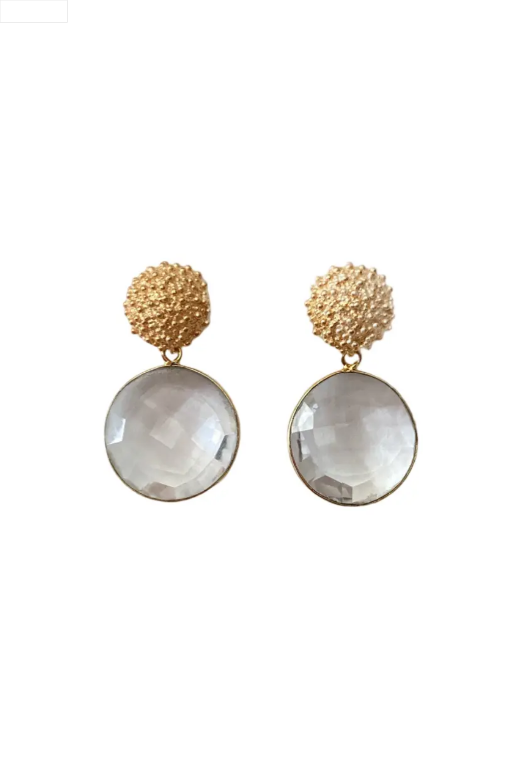 Pair of earrings with round clear stones and textured gold tops on a white background