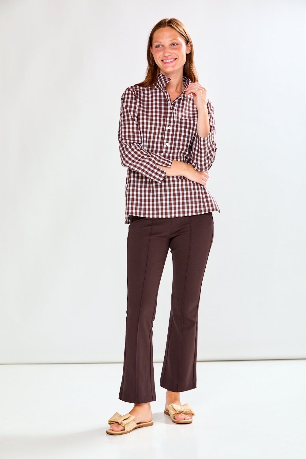 Woman in chocolate/white check top