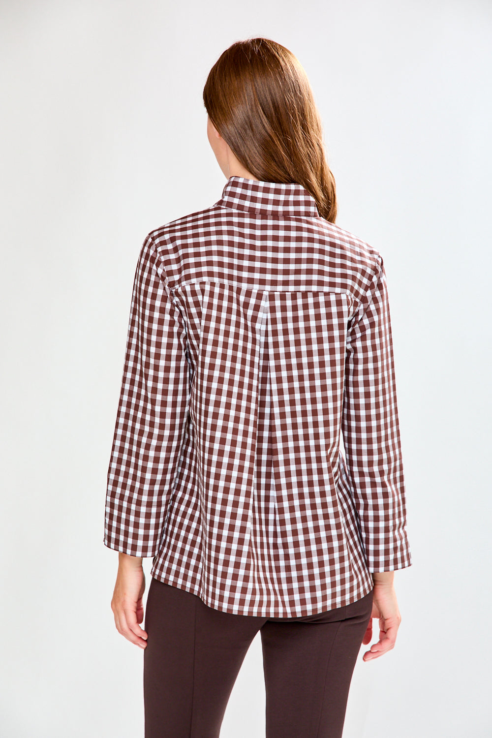 Woman in chocolate/white check top