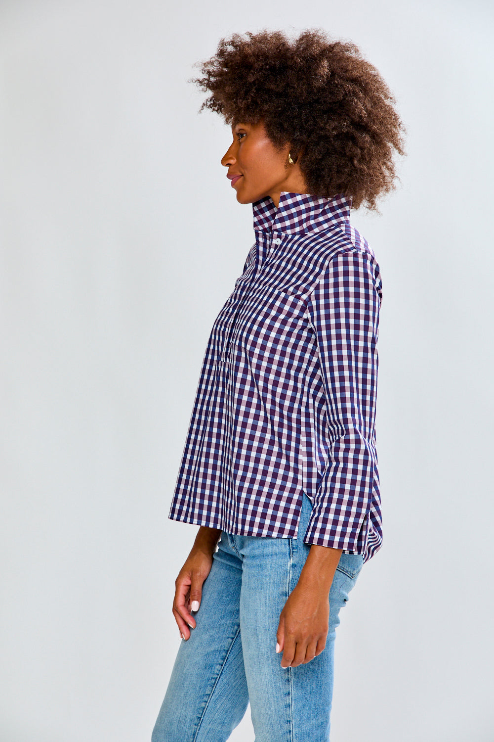 Woman in eggplant/white check top