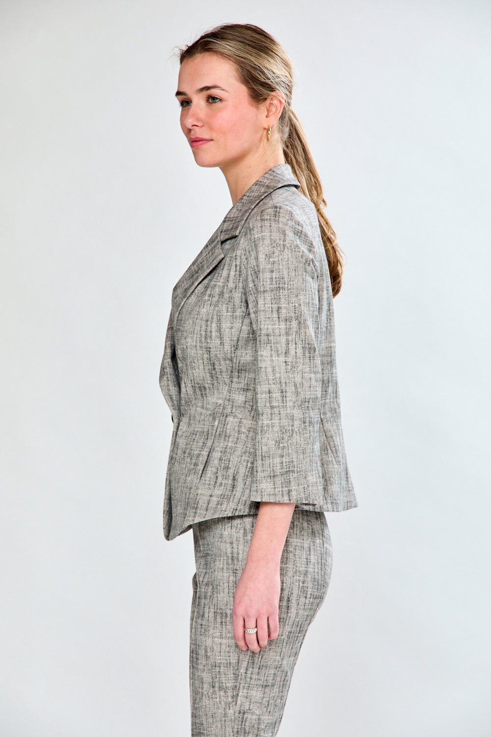 Woman wearing sand and black jacket