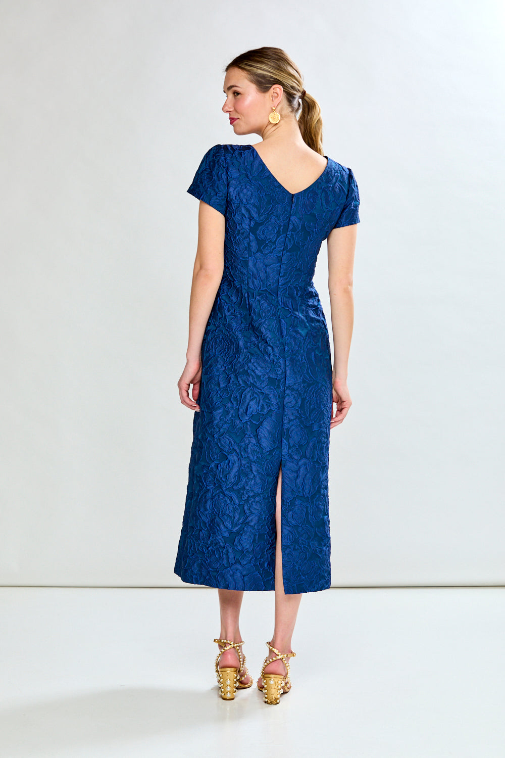 Woman in navy tea length dress