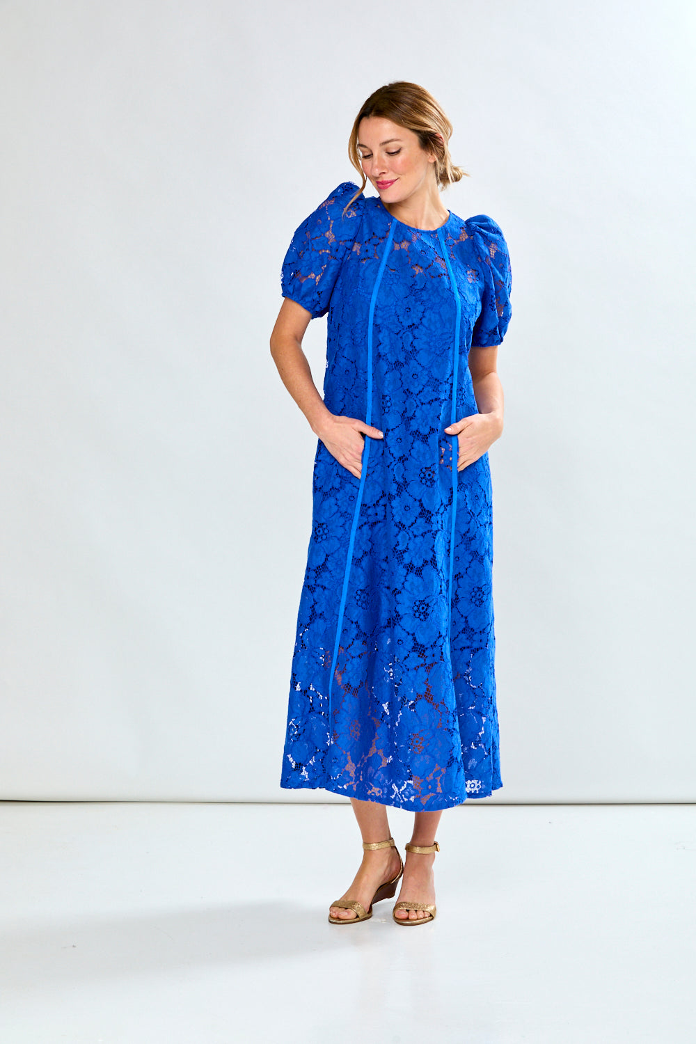 Woman in royal eyelet dress