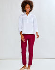 Woman wearing a white shirt and red pants on a white background
