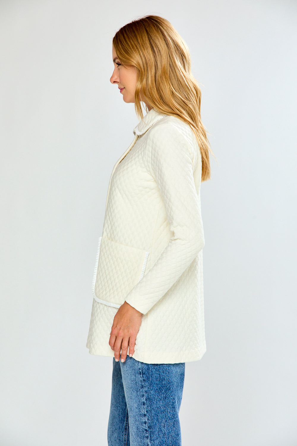 Woman wearing an ivory quilted jacket