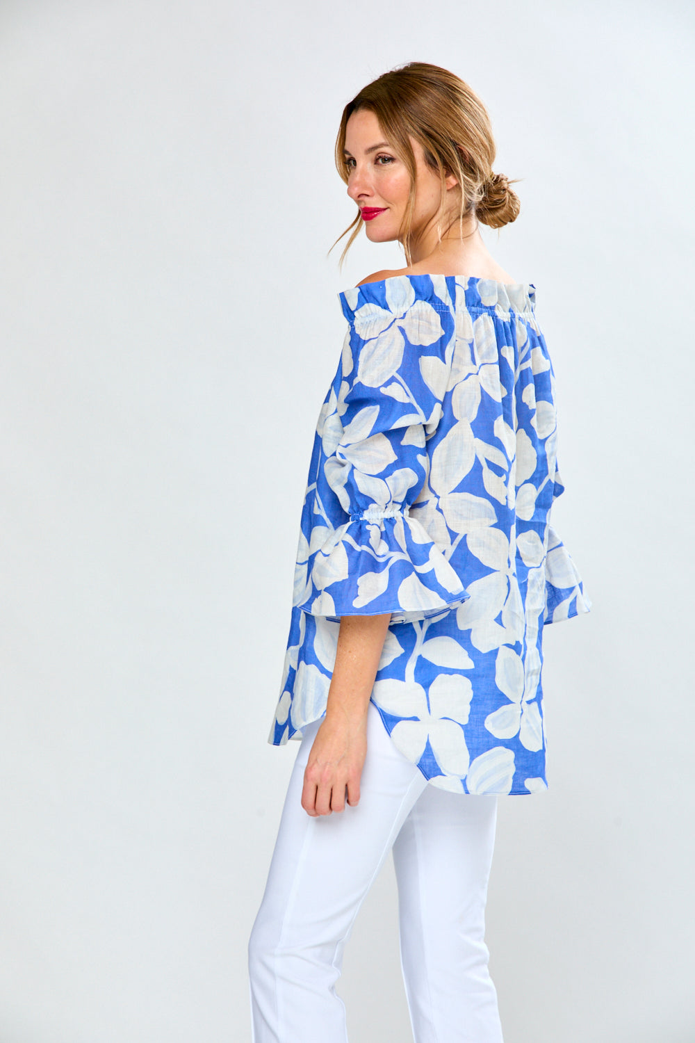 Woman in cobalt leaf print top
