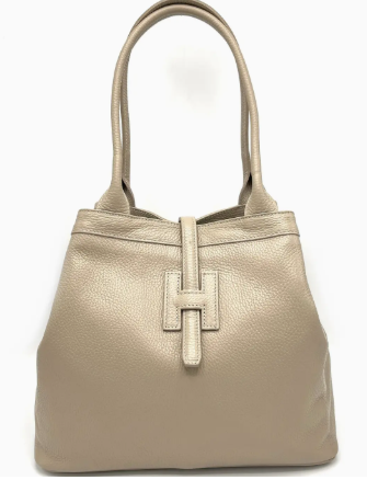 Beige handbag with a prominent logo on a white background