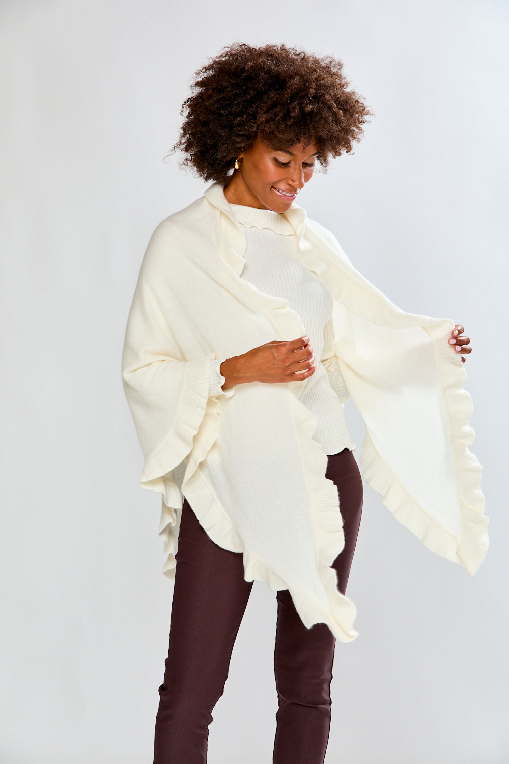 Woman wearing a white scarf against a plain background