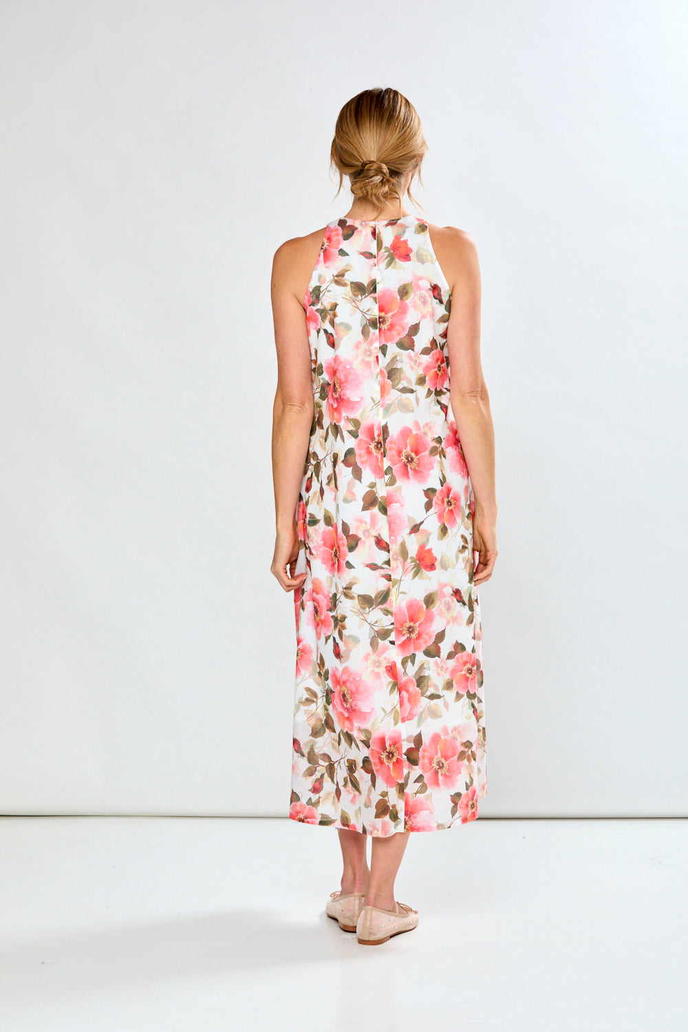 Woman in coral poppies dress