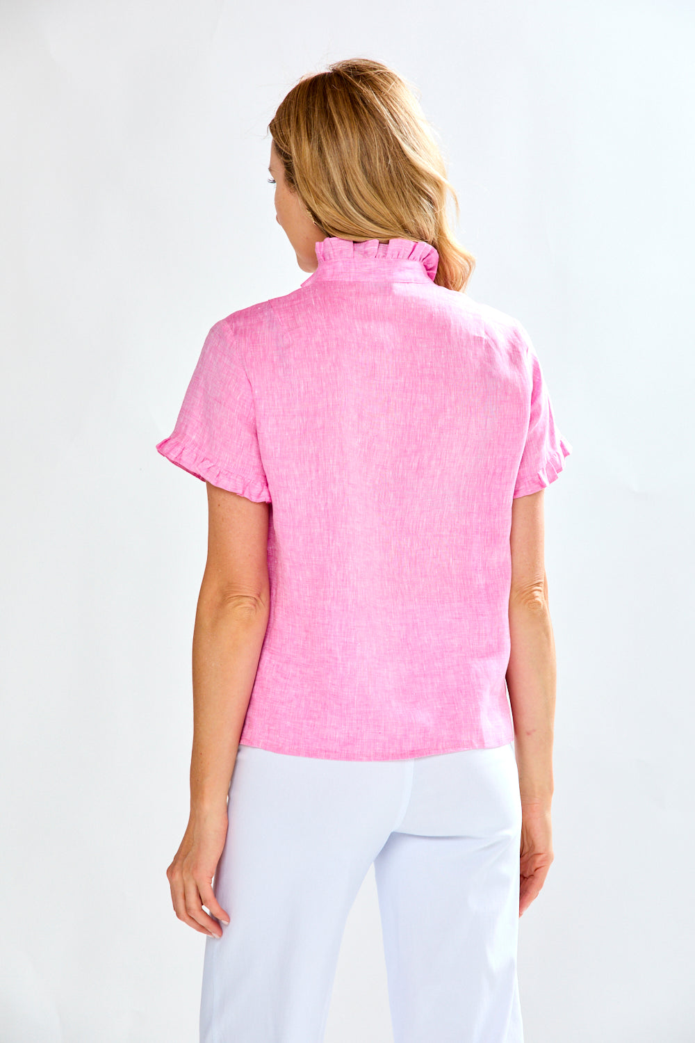 Woman in fuchsia short sleeve linen blouse