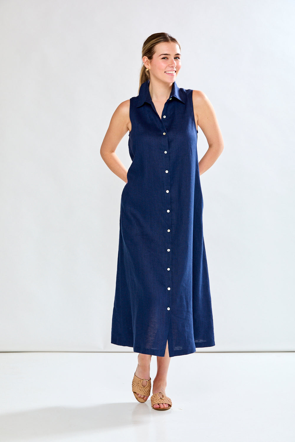 Woman in navy sleeveless dress