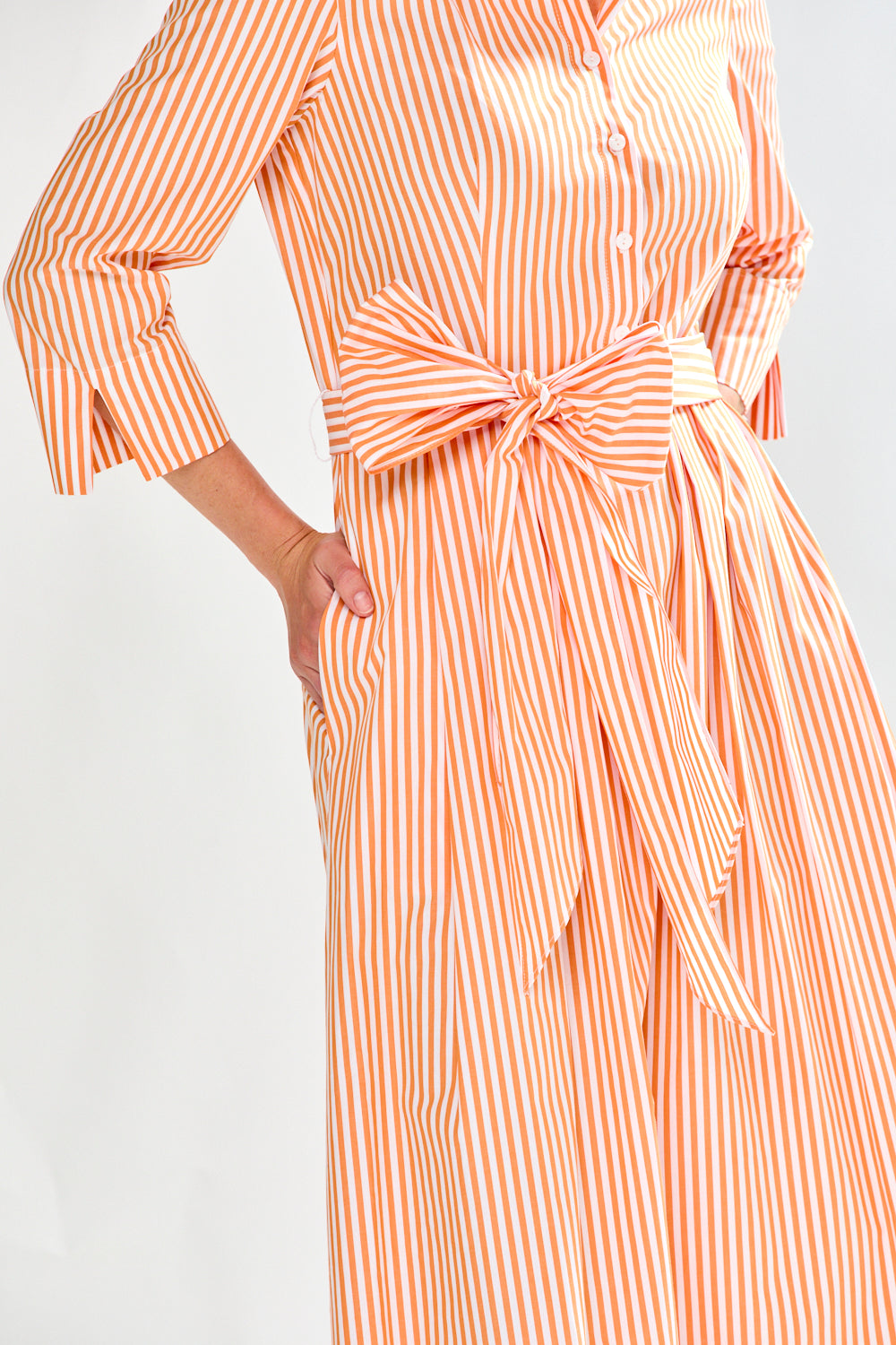 Woman in orange stripe dress